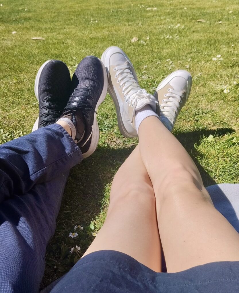 Two people relaxing on the grass in Lisbon on a sunny day