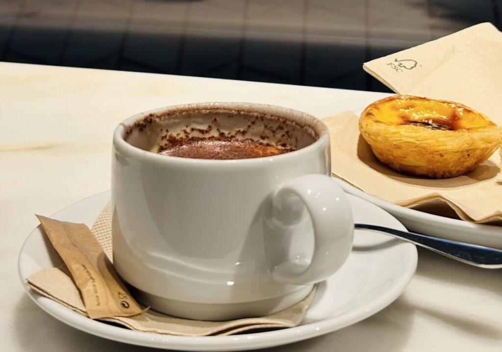 Pastel de nata and hot chocolate at a Lisbon café during the first date