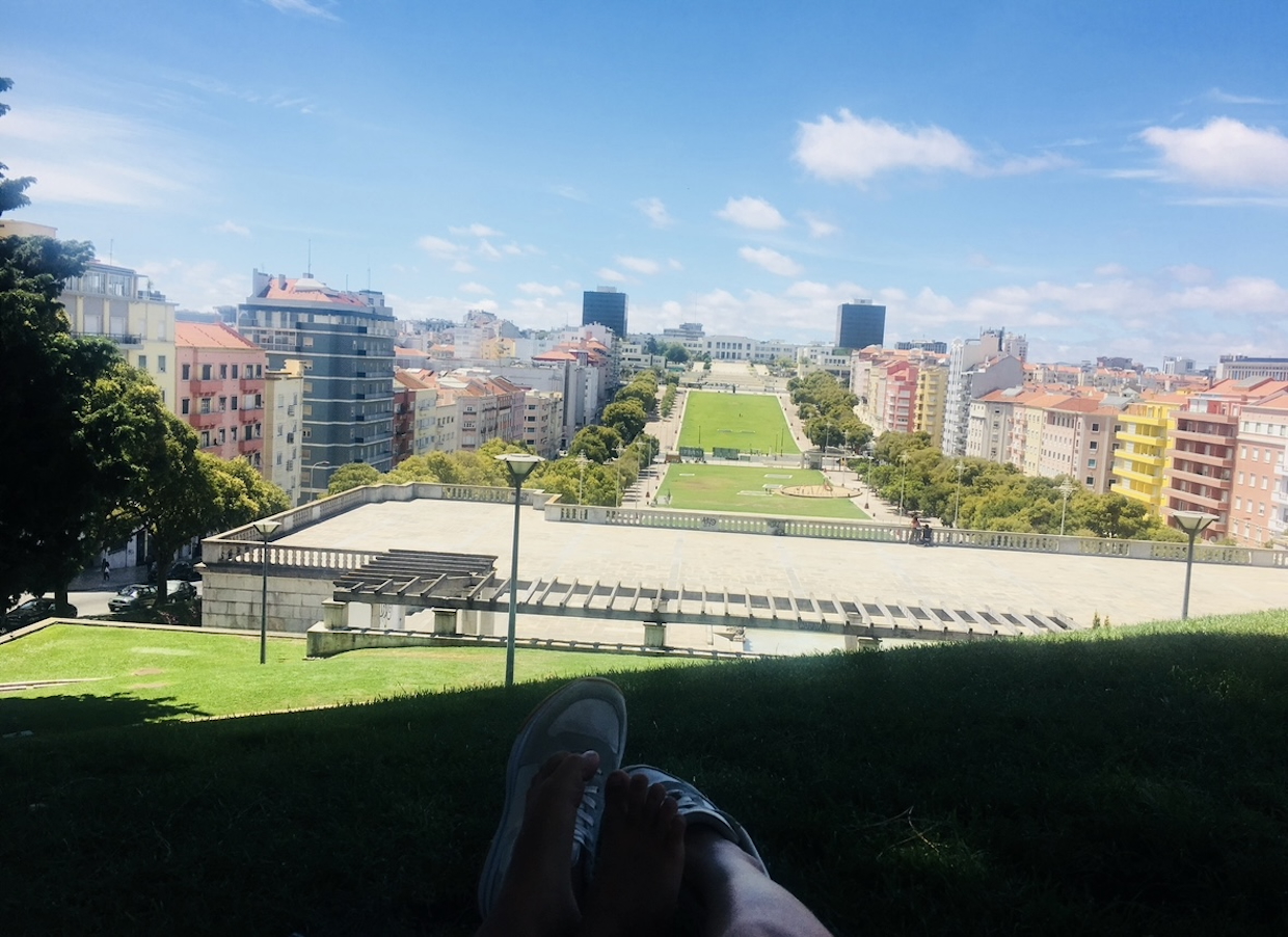View over Alameda in Lisbon from a shaded hilltop spot on a sunny day.