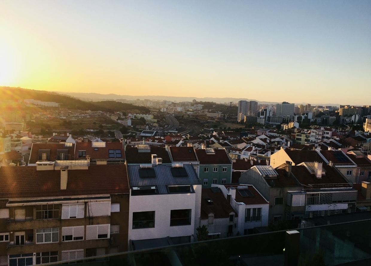 Sunset view over rooftops and skyline in Campolide, Lisbon