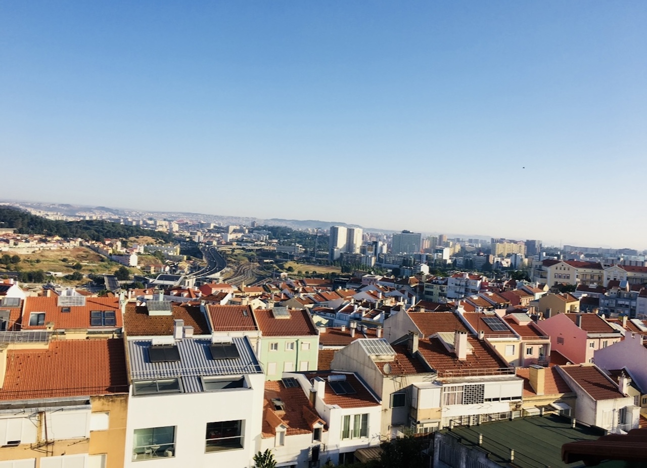 View over Lisbon rooftops and skyline from Campolide in morning light