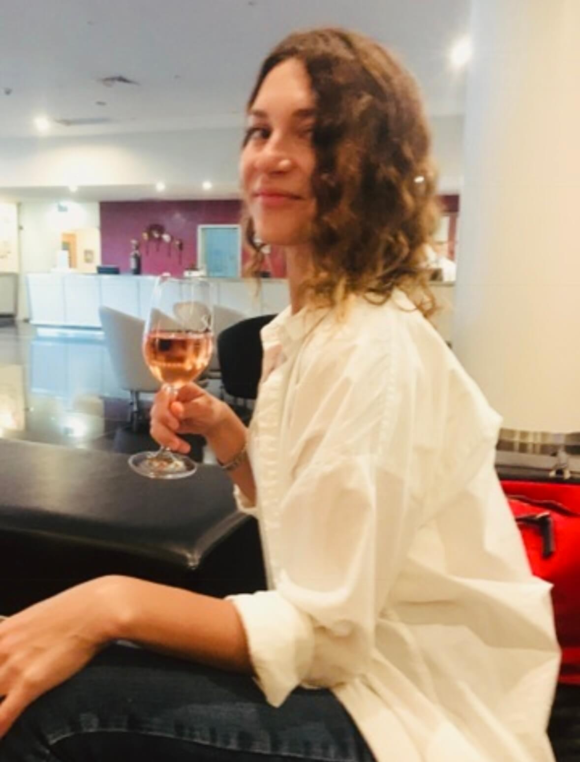 Enjoying a glass of wine while working remotely in the luxurious lobby of Vila Galé Ópera hotel in Lisbon.